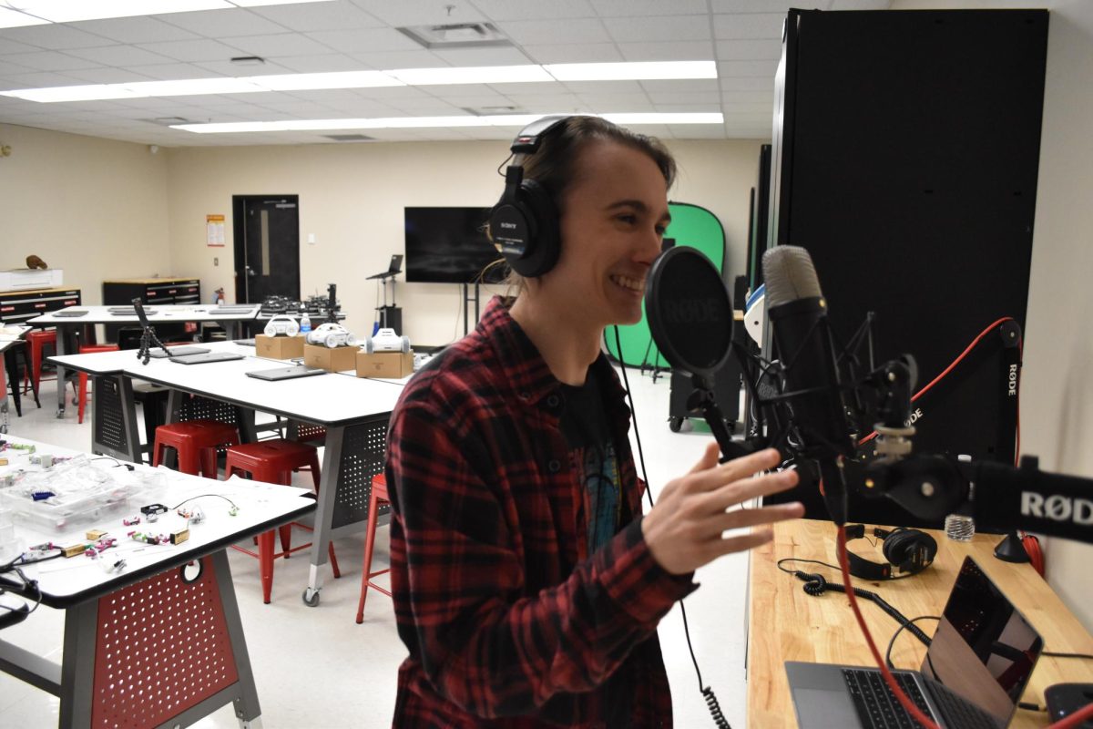 Gavin Harrington fiddles with the podcasting equipment.