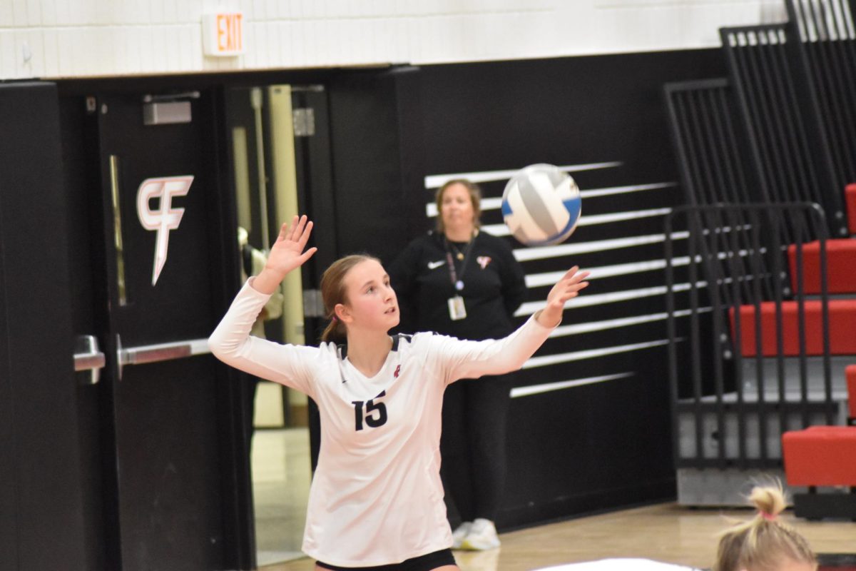 Claire Meyers serves the ball.