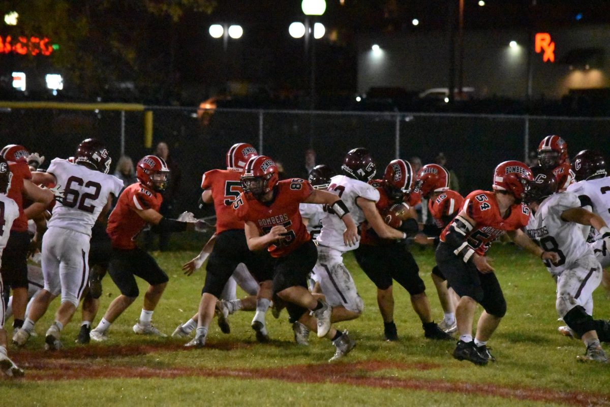 The Cannon Falls Football team bolts in all directions to stop their opponents and defend the ball. 