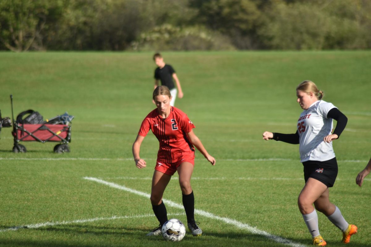 Maddison Jeppesen prepares to kick the ball away from her opponent.