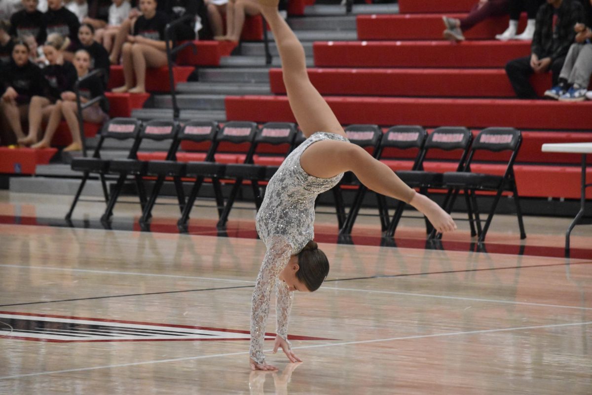 Katie Maziarka goes into a handspring as a part of her routine.