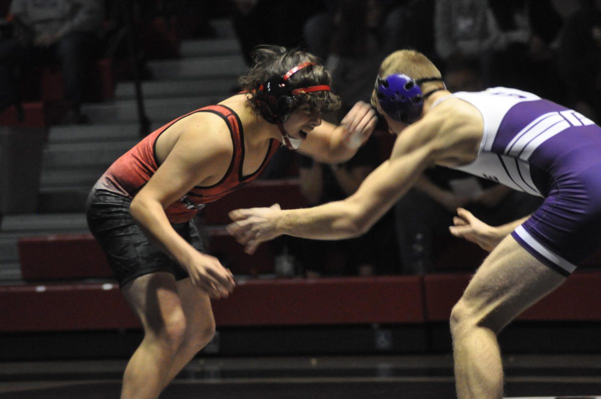 Jaeden Baird grapples with his opponent on the mat.