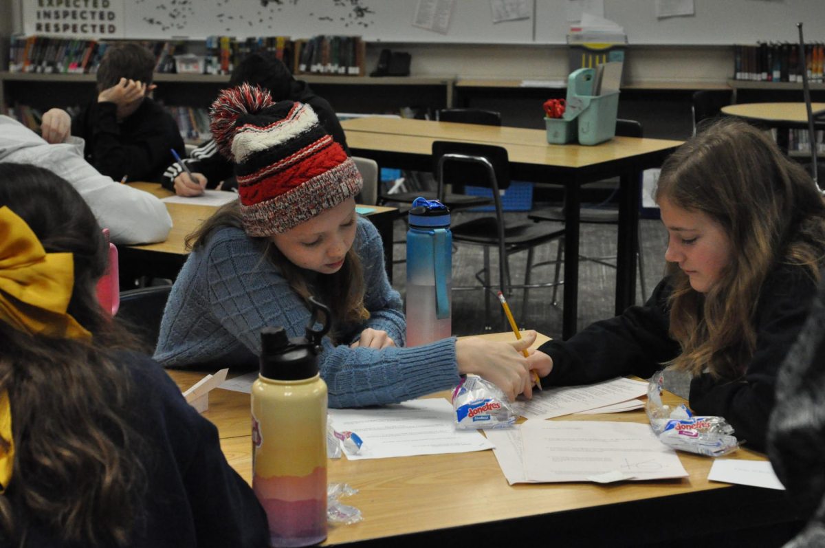 Anya Naygaard and Madelyn Thompson work on a math problem together
