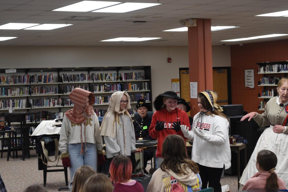 Many six grade girls get to try on historical women attire.