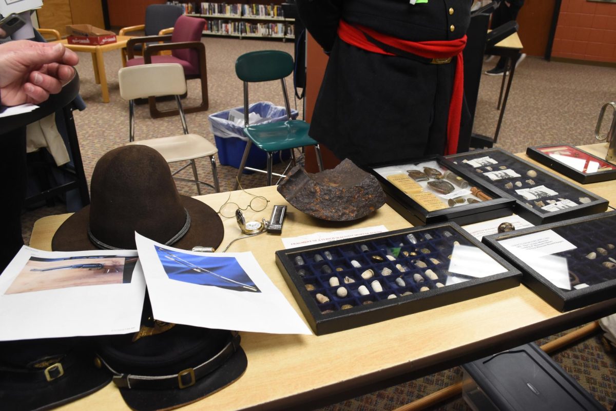 The reenactors showcases many artifacts to the 6th graders.