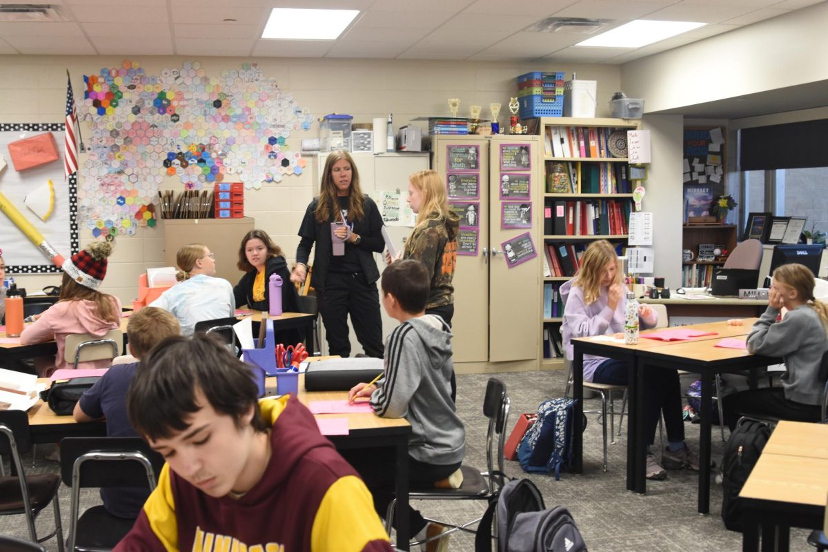 Coach Jaime Miller works with a large group of middle school math team members