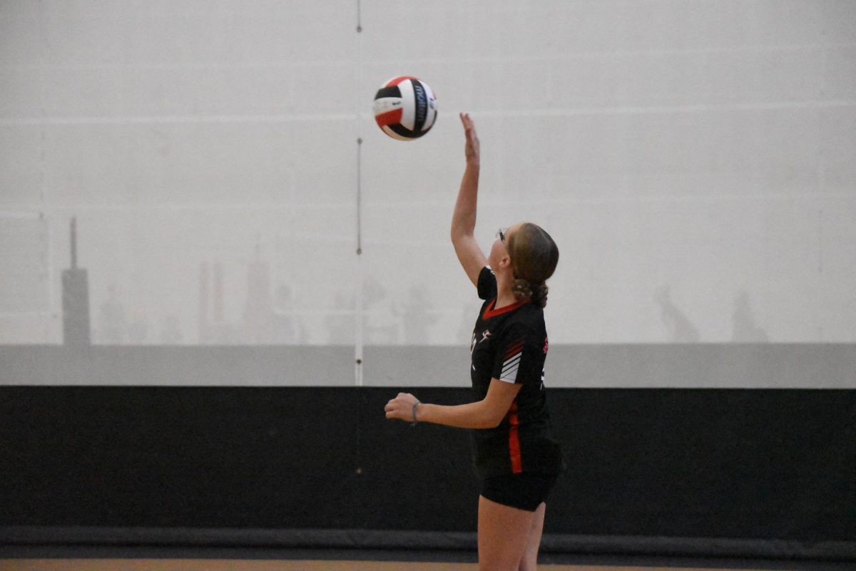 Kayla Kiffmeyer serves the ball