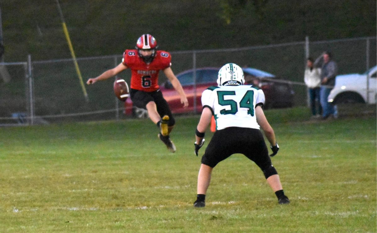 Gavin Moorhead kicks the ball in the air 