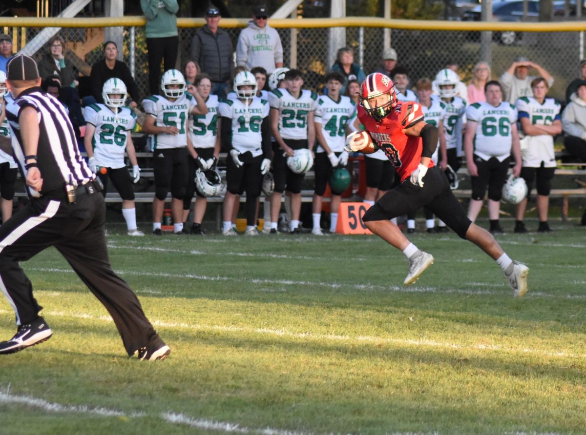 Preston Schoenfelder runs the ball and looks for defenders 