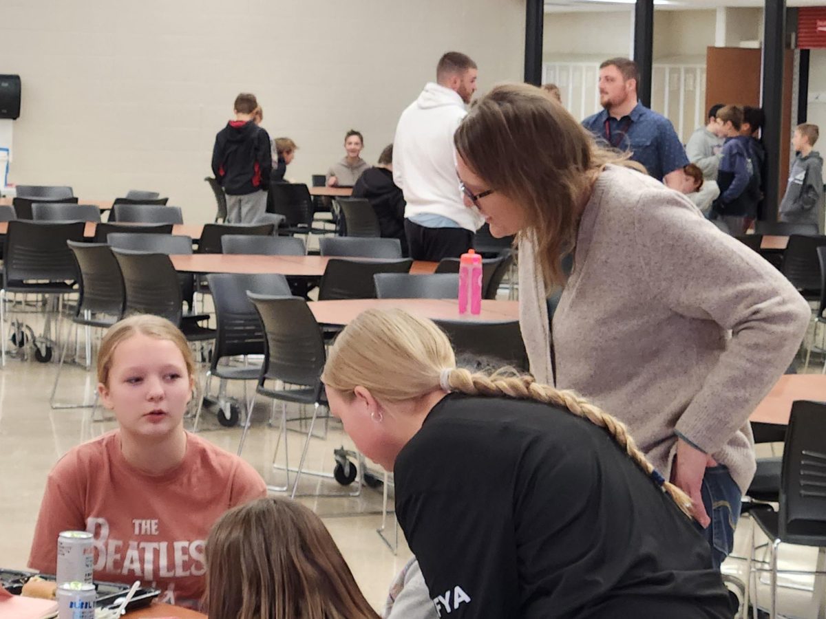 Ms. Thompson counsels 6th grade students during lunch.