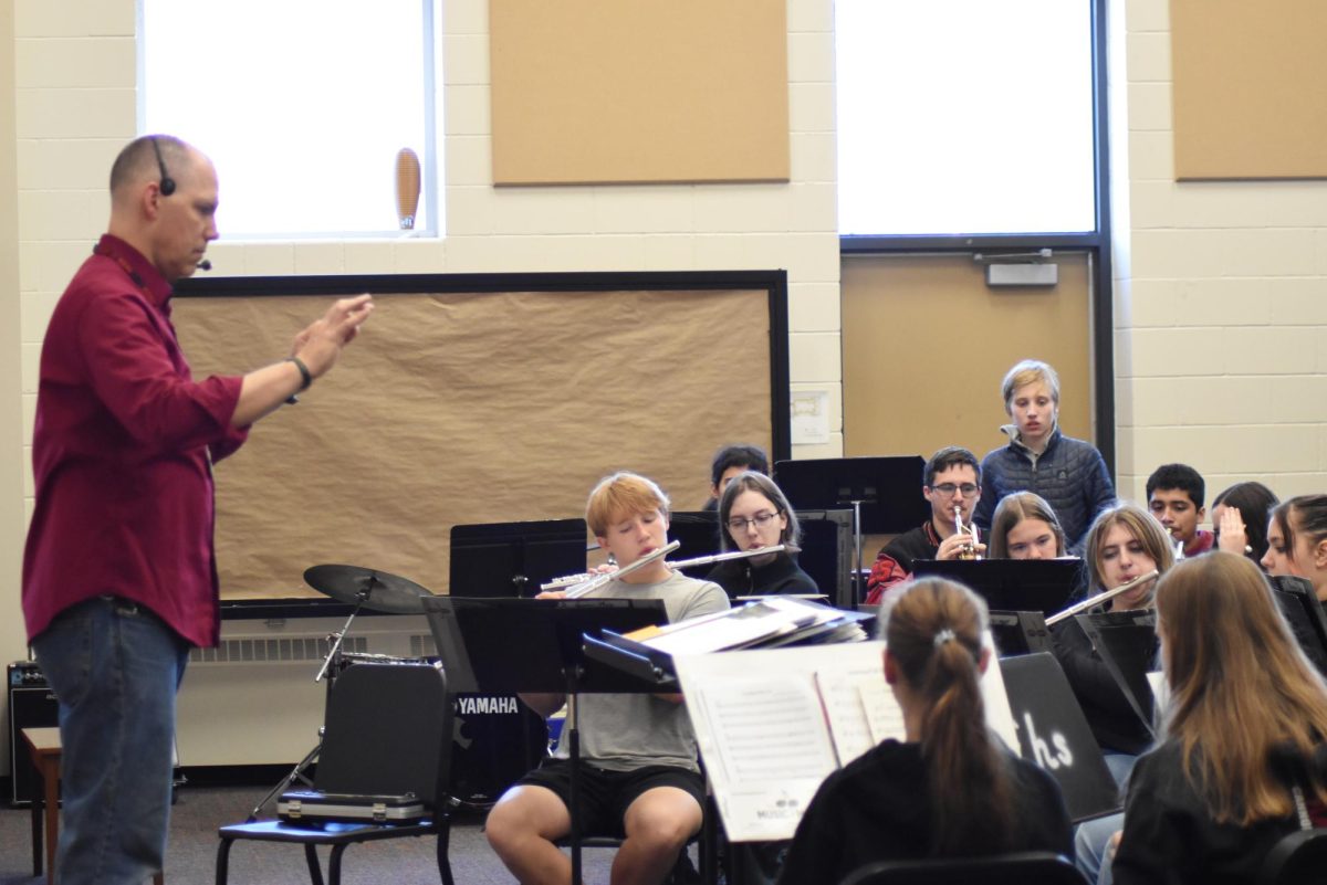 Band director Mike Legvold prepares his musicians for the upcoming holiday concert