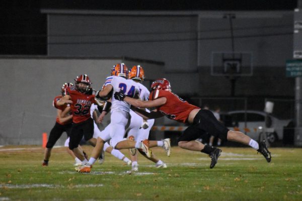 Bomber players gang-tackle opponent in final playoff game