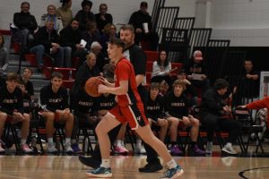 Junior Ryan Hjellming dribbles the basketball.