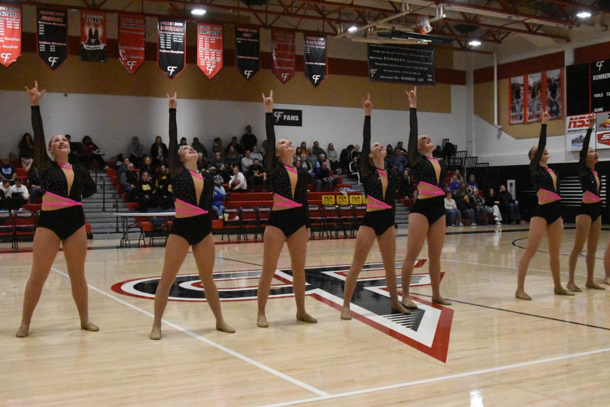 Dancers hit their ending pose of their kick dance.