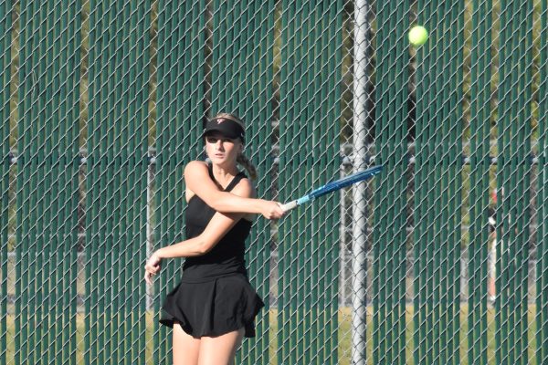 Junior Sophia Nerison hits the tennis ball.