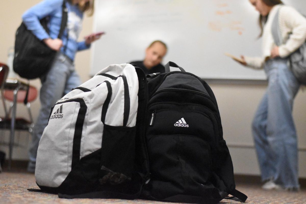 A group of students in a classroom with backpacks