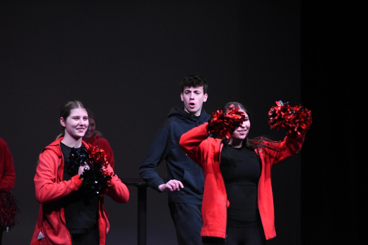 Addison Miller and Adelaide Anderson cheer as Gavin Johnson goes past them.