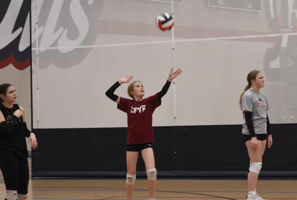 Brekkyn Ayres serves the ball during JO practice