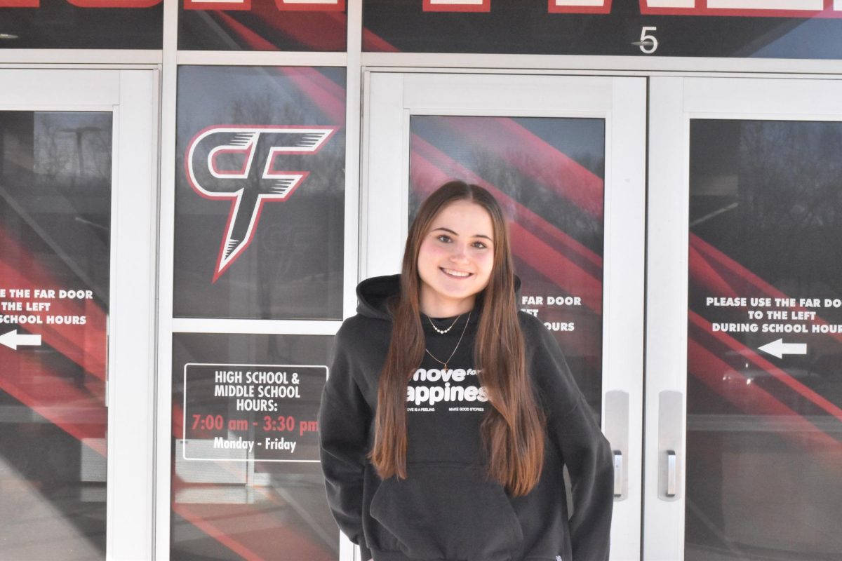 Luana Hyla in front of the Cannon Falls High School building