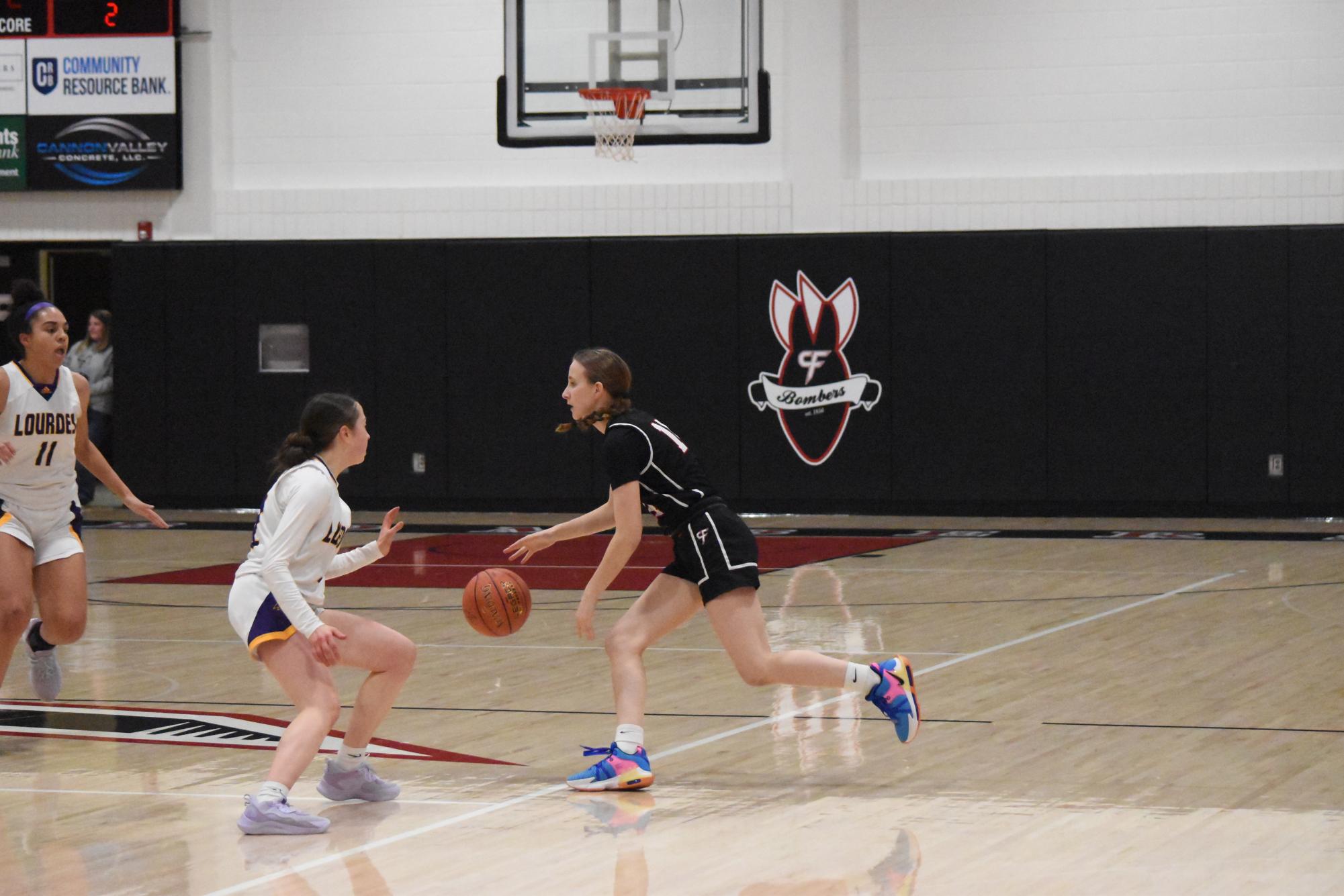 Freshman Claire Meyers dribbles the basketball.