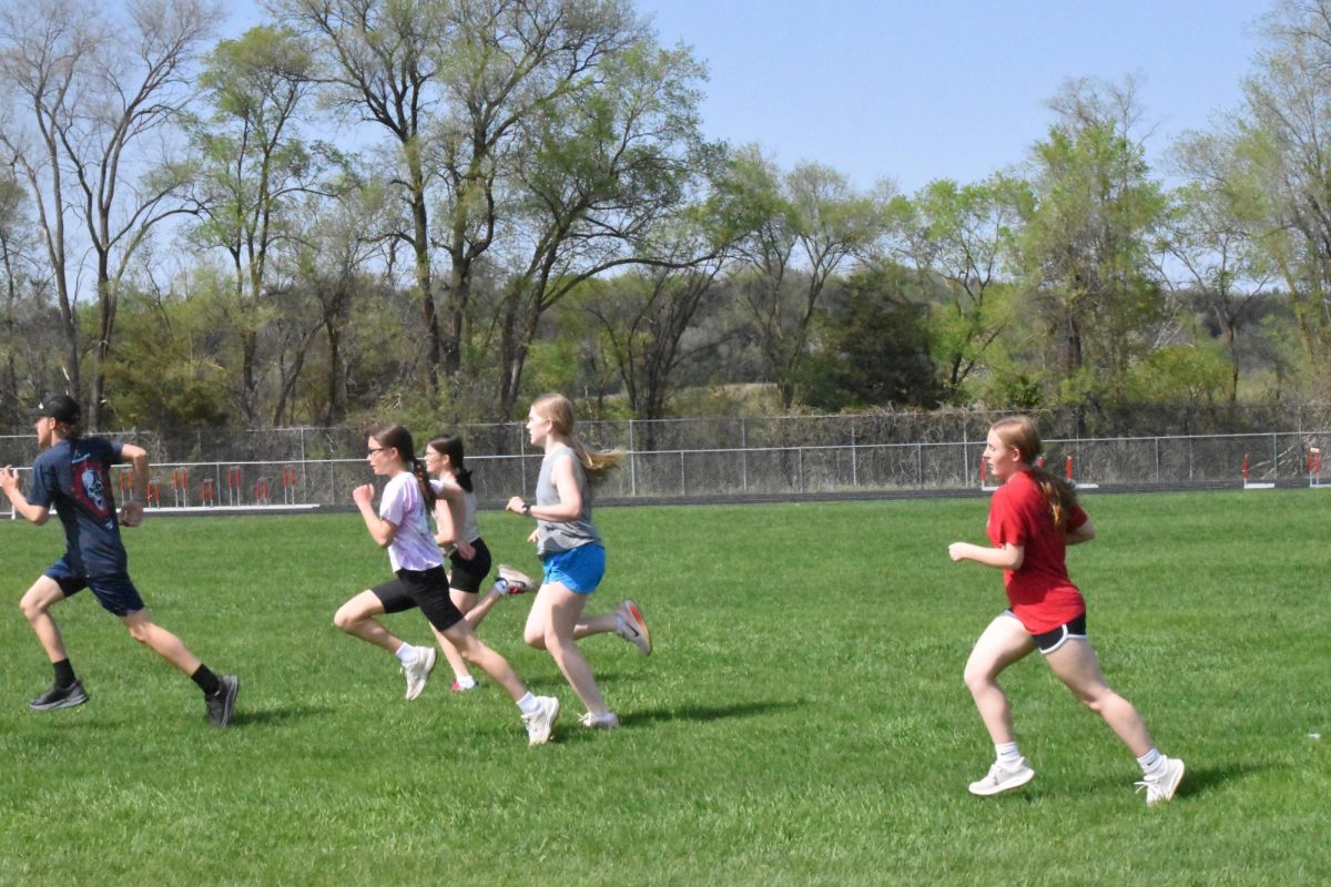 Girls and boys Jr. High Track run a sprint.