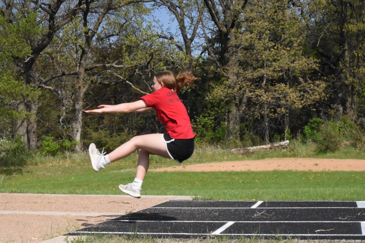 8th grader Kia Maki practices her form for long jump.