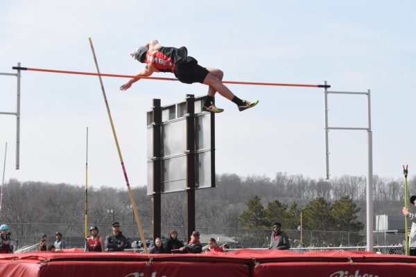 Junior trackster Graham Bray completes a pole vault.