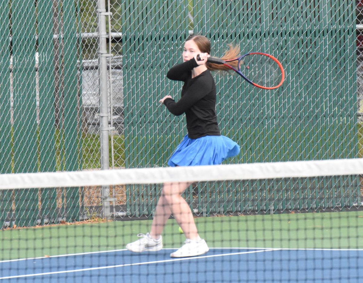 Noelle Swenson finishes a forehand hit during warm-ups.