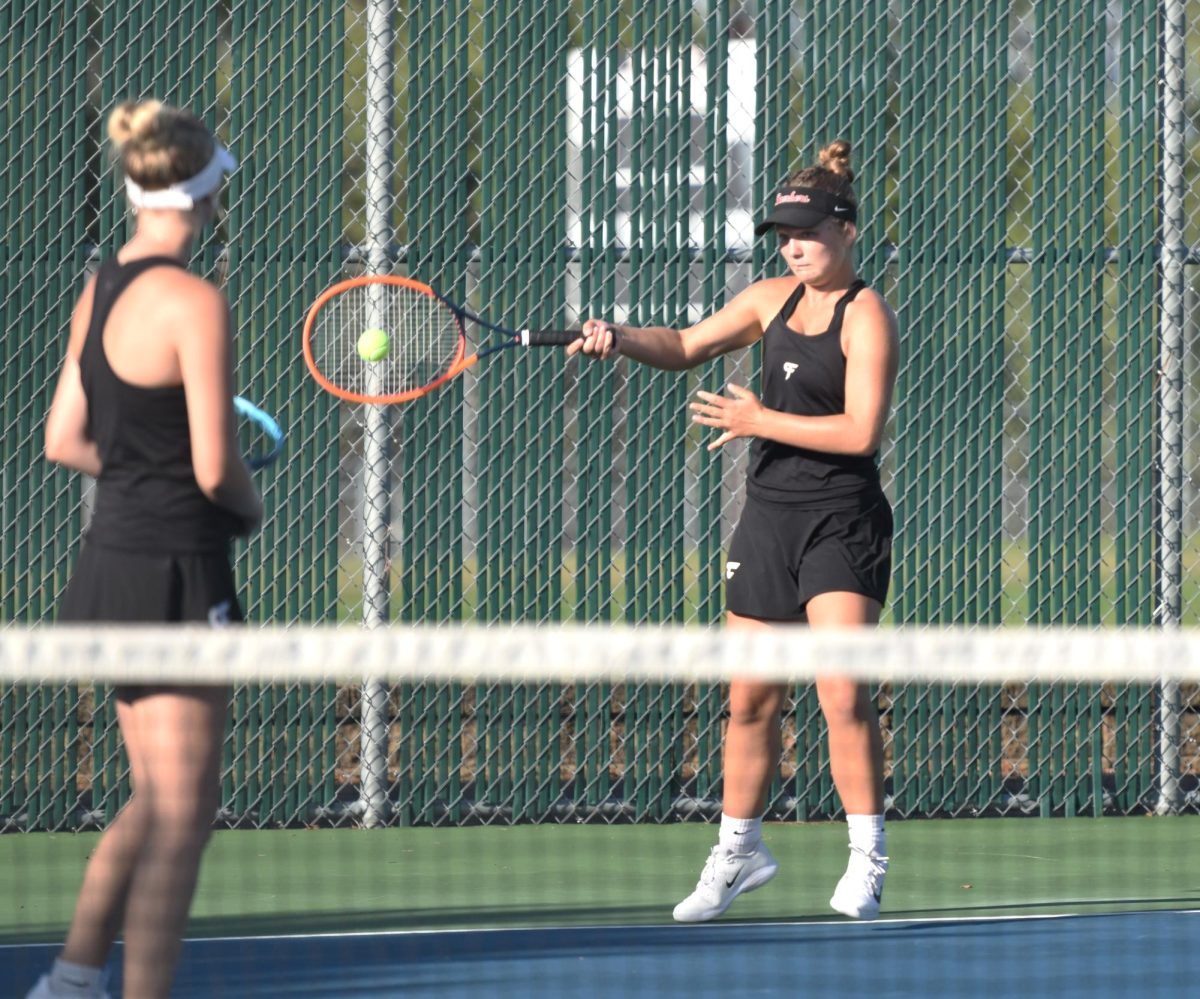 Seniors, Josie Sjoquist and Sophia Nerison, play a doubles match together on Senior Night.