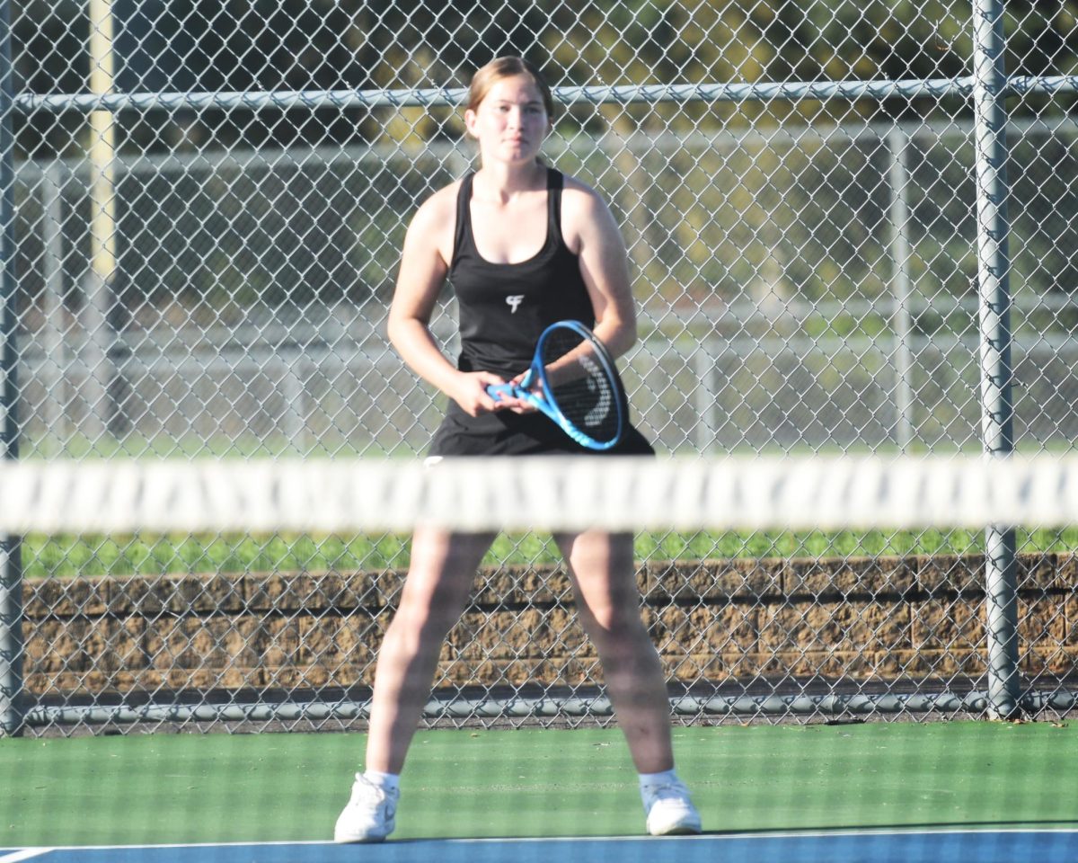 Noelle Swenson waits for her opponent to serve during a doubles match.