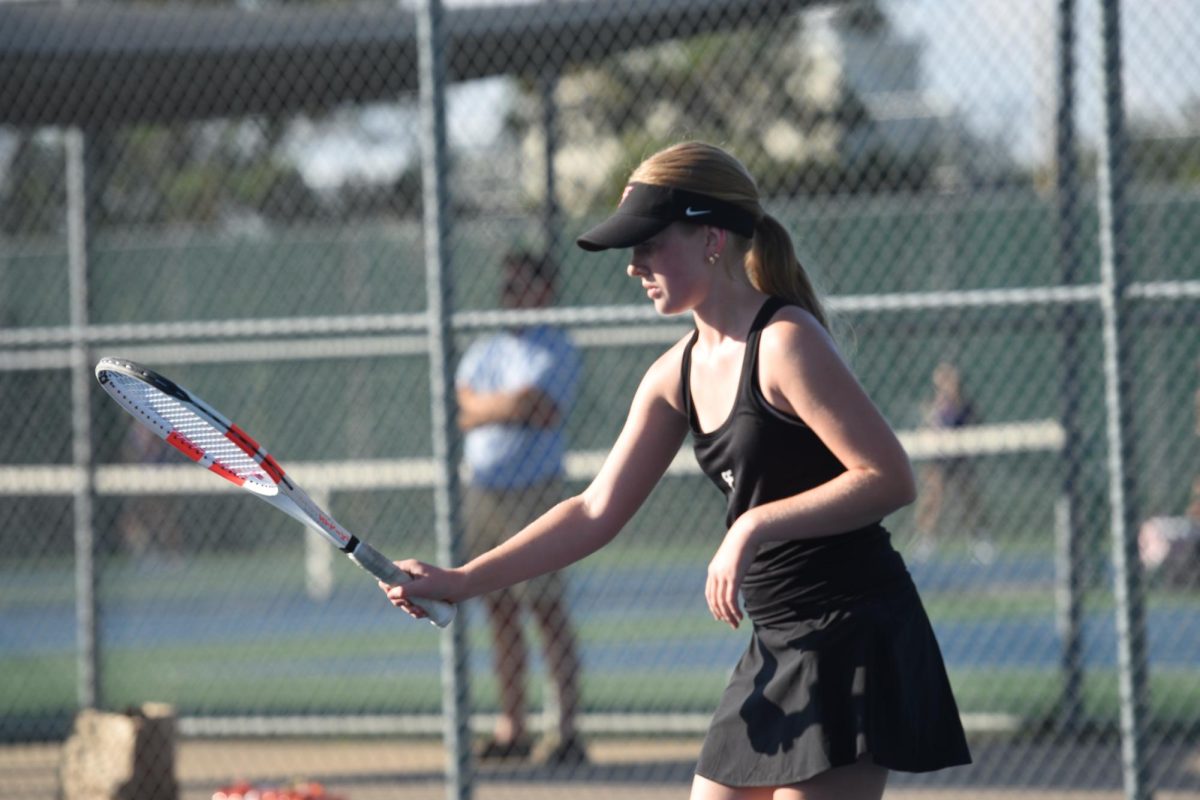 Marissa Mandelkow bounces the tennis ball with her racket during warm-ups.