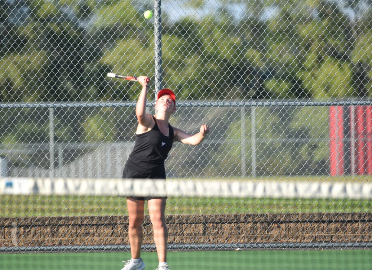 Alyssa Burgess serves to her opponent.