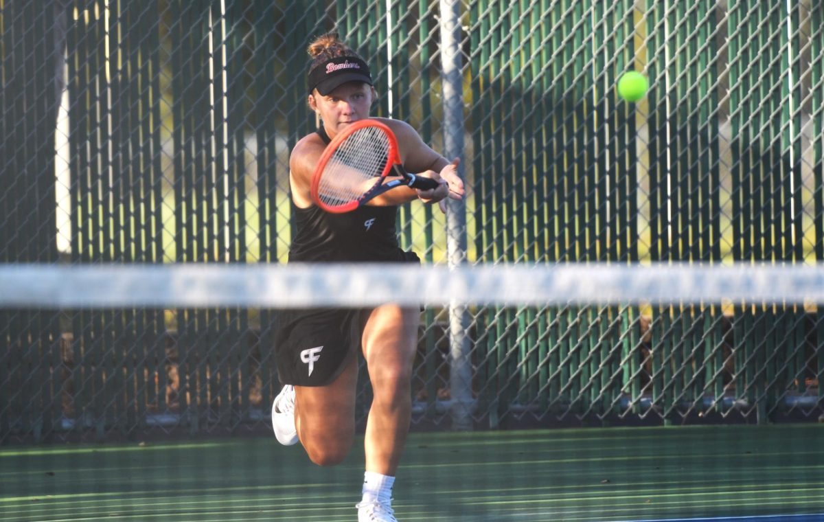 Josie Sjoquist aims to hit a forehand groundstroke in her singles match.