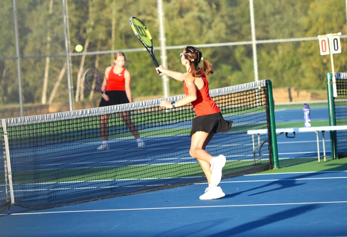 Kinley Sheller ends the point with a volley at the net.