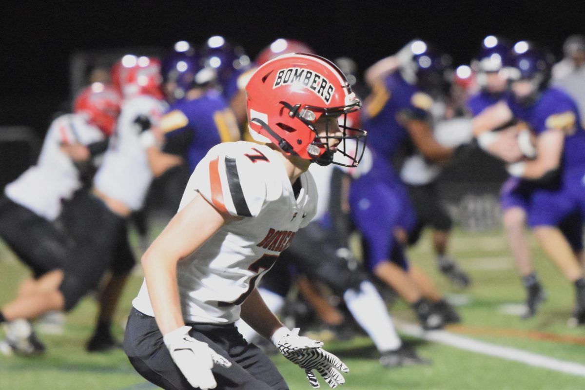 Bomber football player Beck Swanson assesses the situation on the field during an away game at Rochester Lourdes.