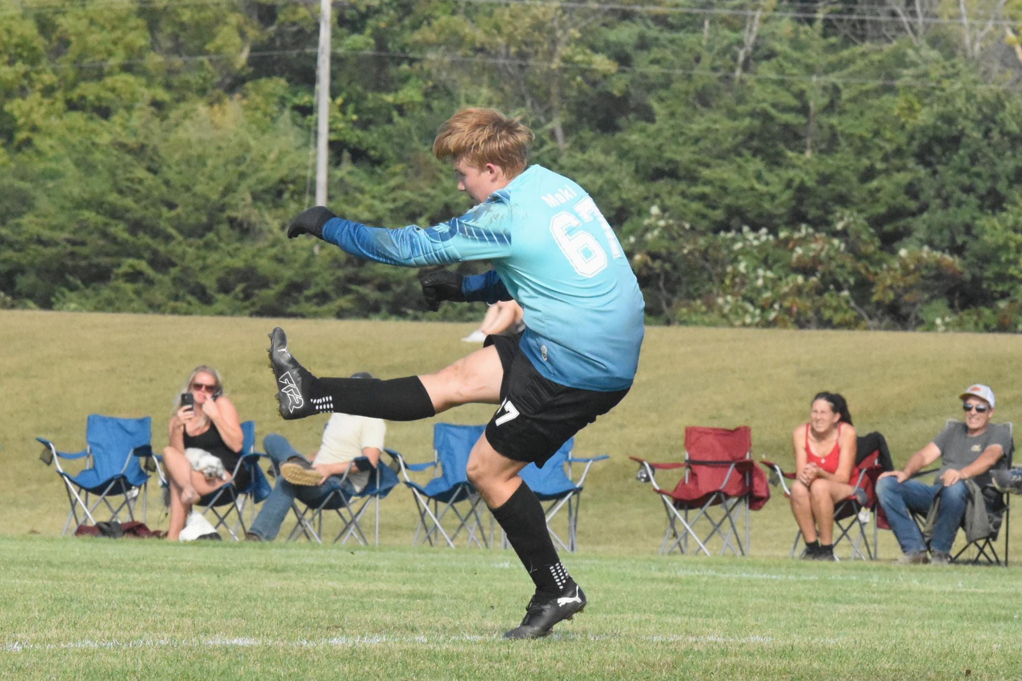 Boys soccer player Gunnar Maki follows through on a kick in a September 2 game against Byron.