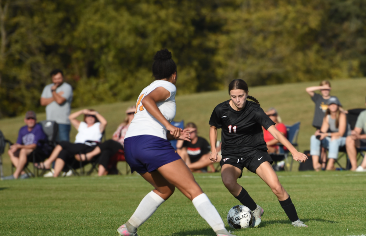 Ava Hernke dribbles around the defender 