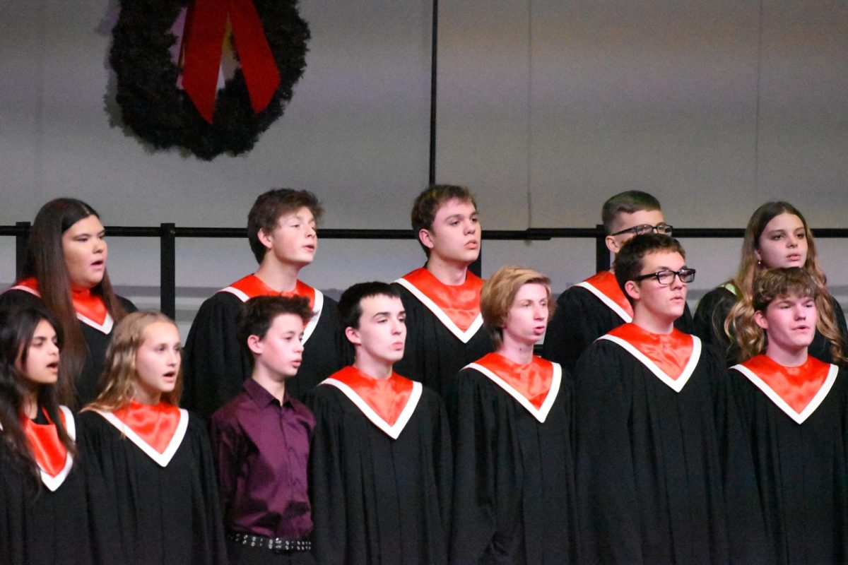 The high school chamber choir sings "That's Christmas to Me" before the concert choir's performance.