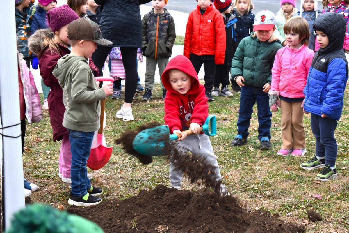 A steep pile of dirt didn't stop this elementary student from pitching in for the tree planting ceremony.