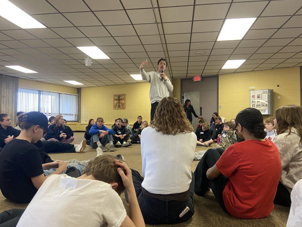One of the Courage Retreat speakers announces the next activity to the group