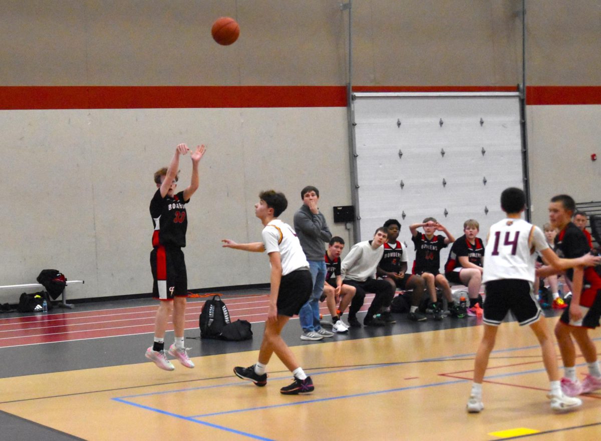 Carter Koppmann shoots a three pointer.