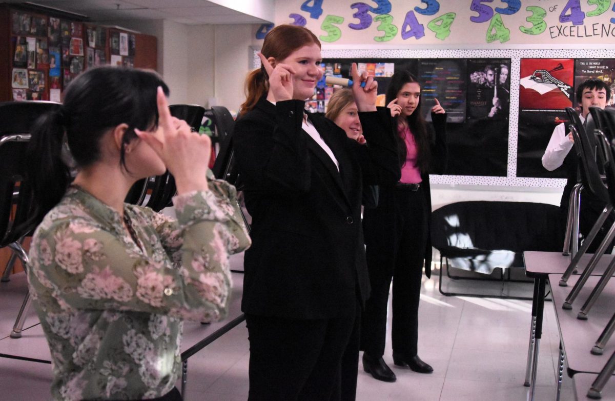 Speech team members go through the warmup exercises at the Rochester tournament