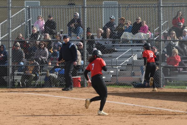 Mya Menge rounds 3rd base and heads home.