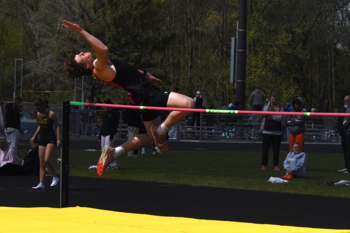 Heinlein nearing the apex of his jump.