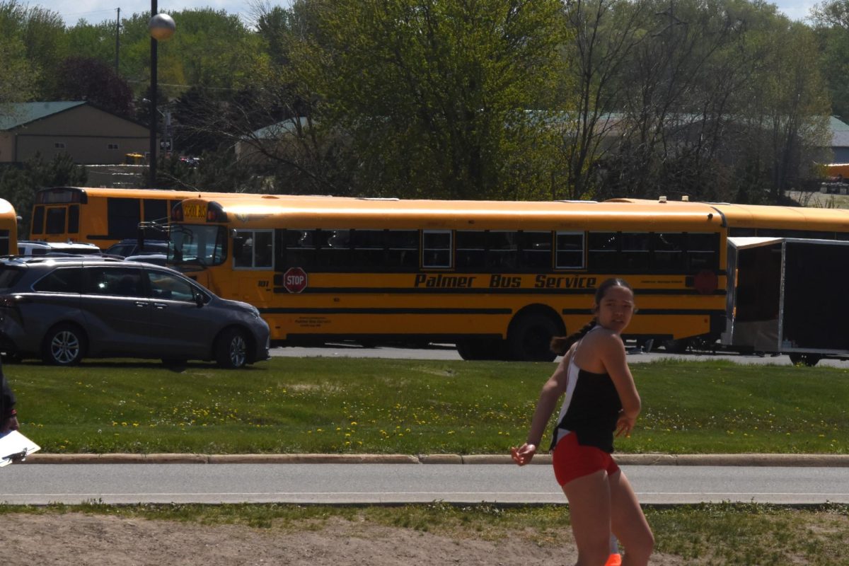 Amy Fick observes her shot in the air (top left corner) at the HVL conference meet on May 9.