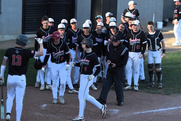 The baseball team celebrates Ryan Hjellming's early-game home run against Randolph on May 9.